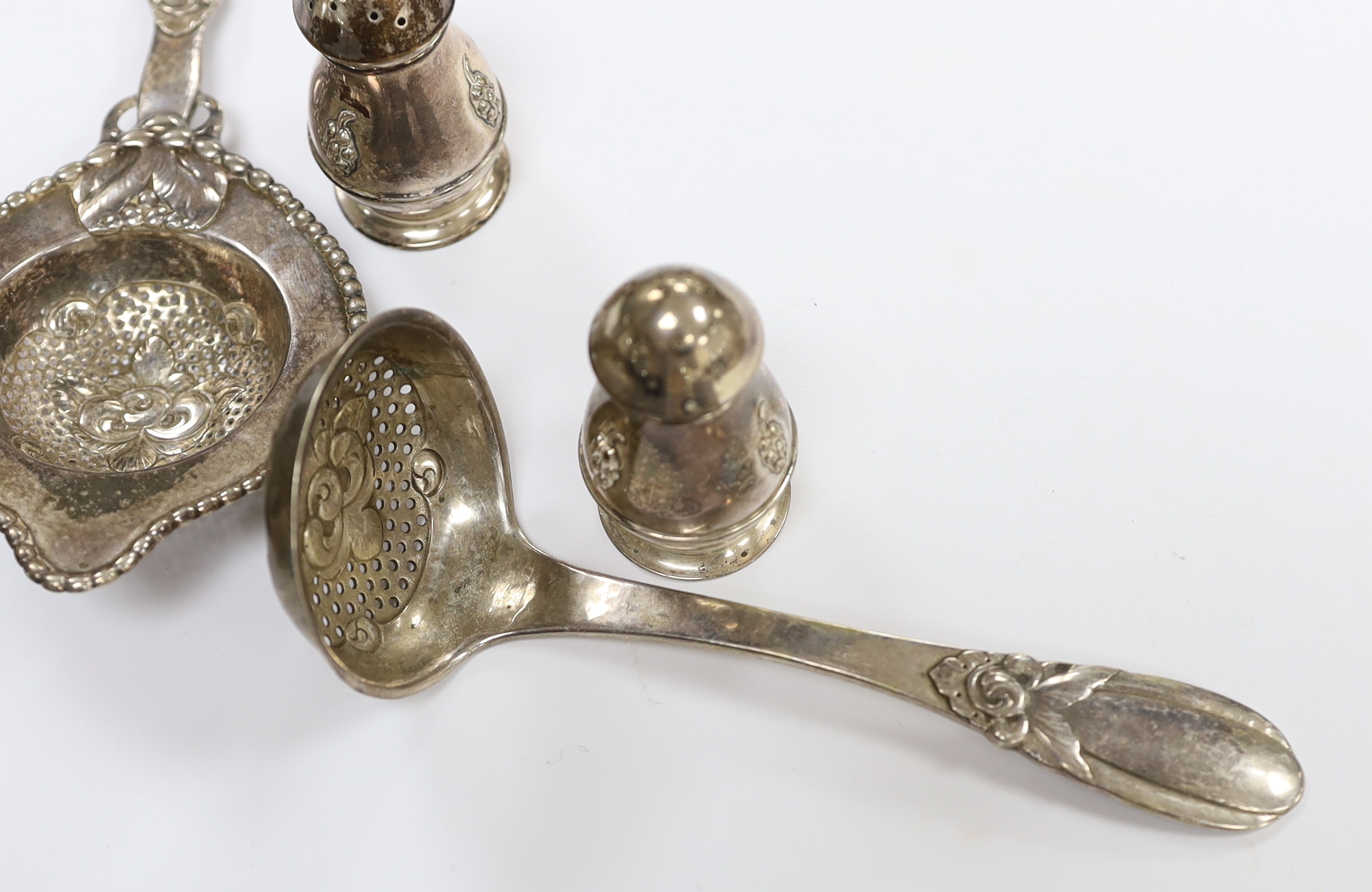 A Danish 830 white metal sifter spoon and tea strainer, by Evald Nielsen and a pair of 1930's Danish white metal condiments.